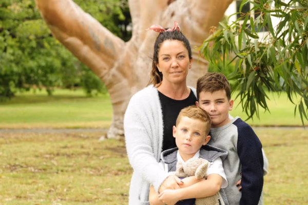 Mother and two sons in park