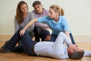 Woman demonstrating turning patient to recovery position