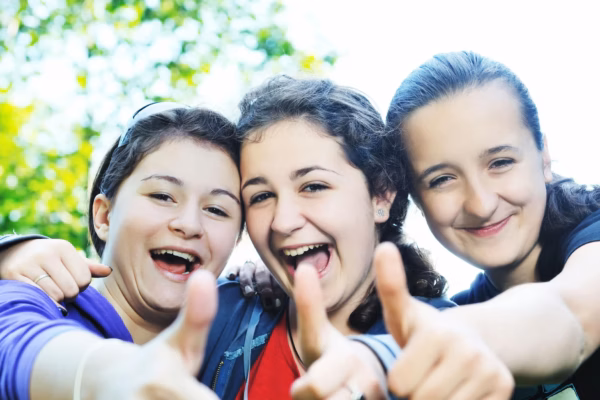 Three girls with thumbs up