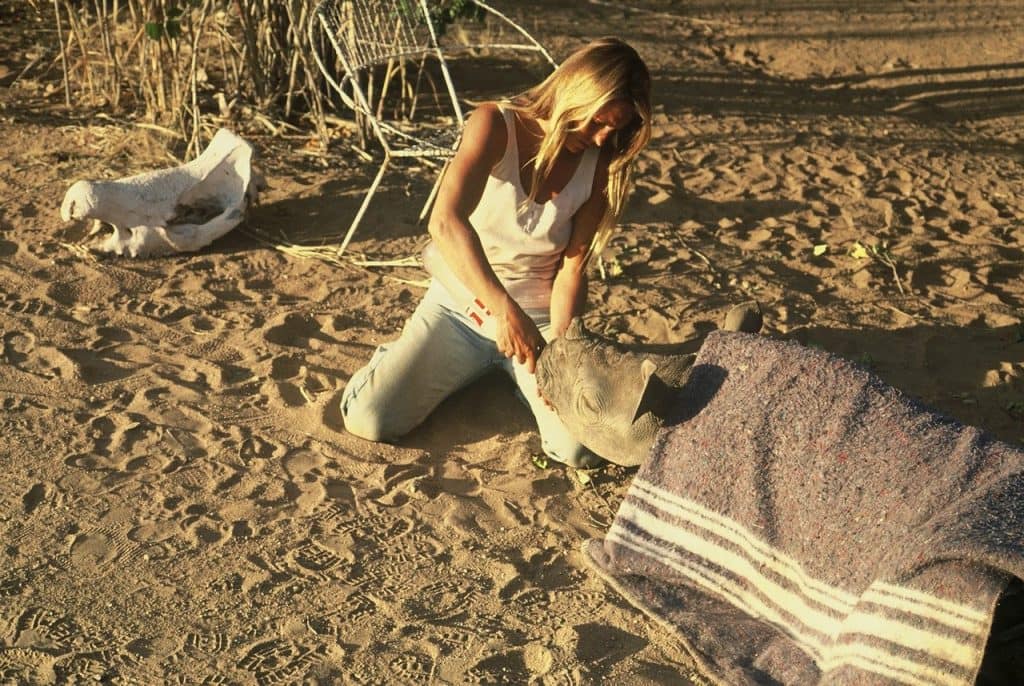 Woman with baby rhino