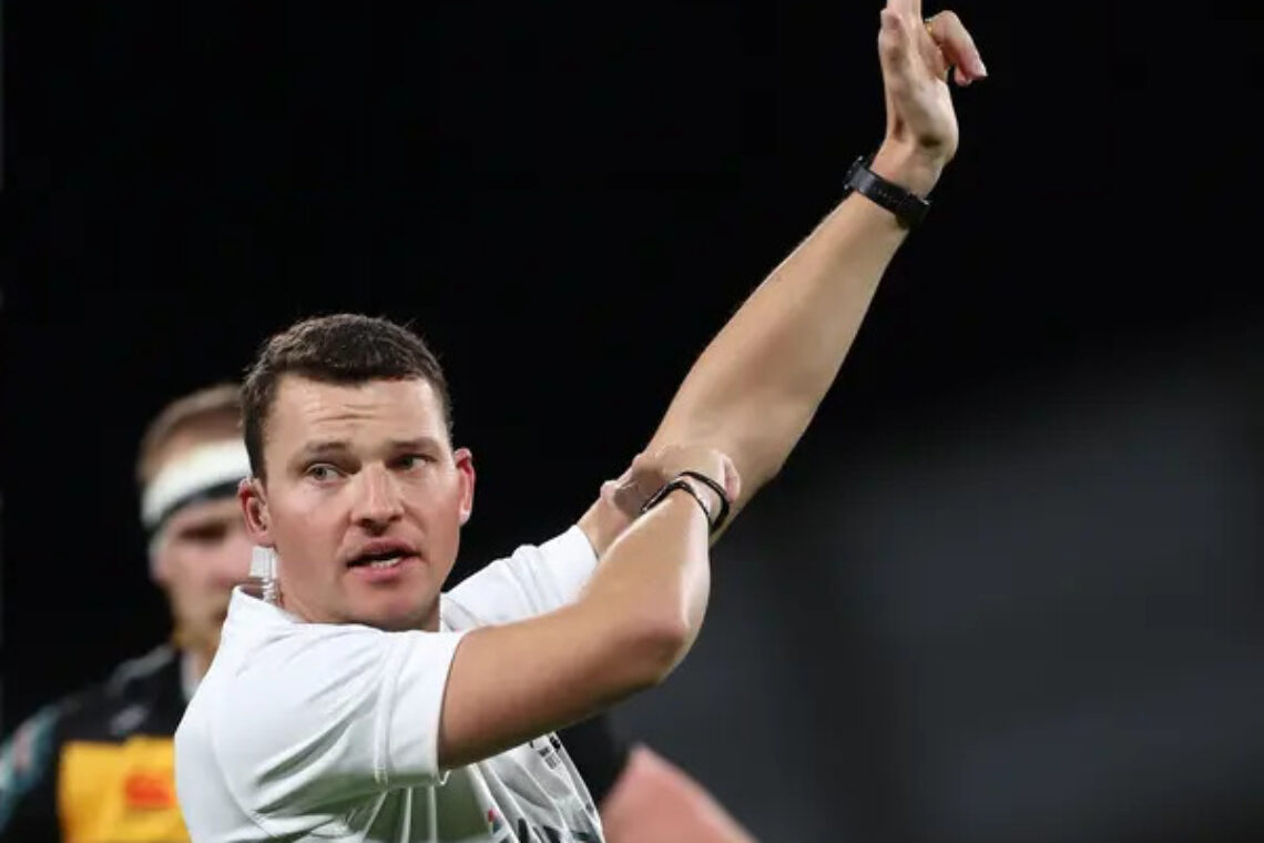 Photo of Angus Mabey refereeing.